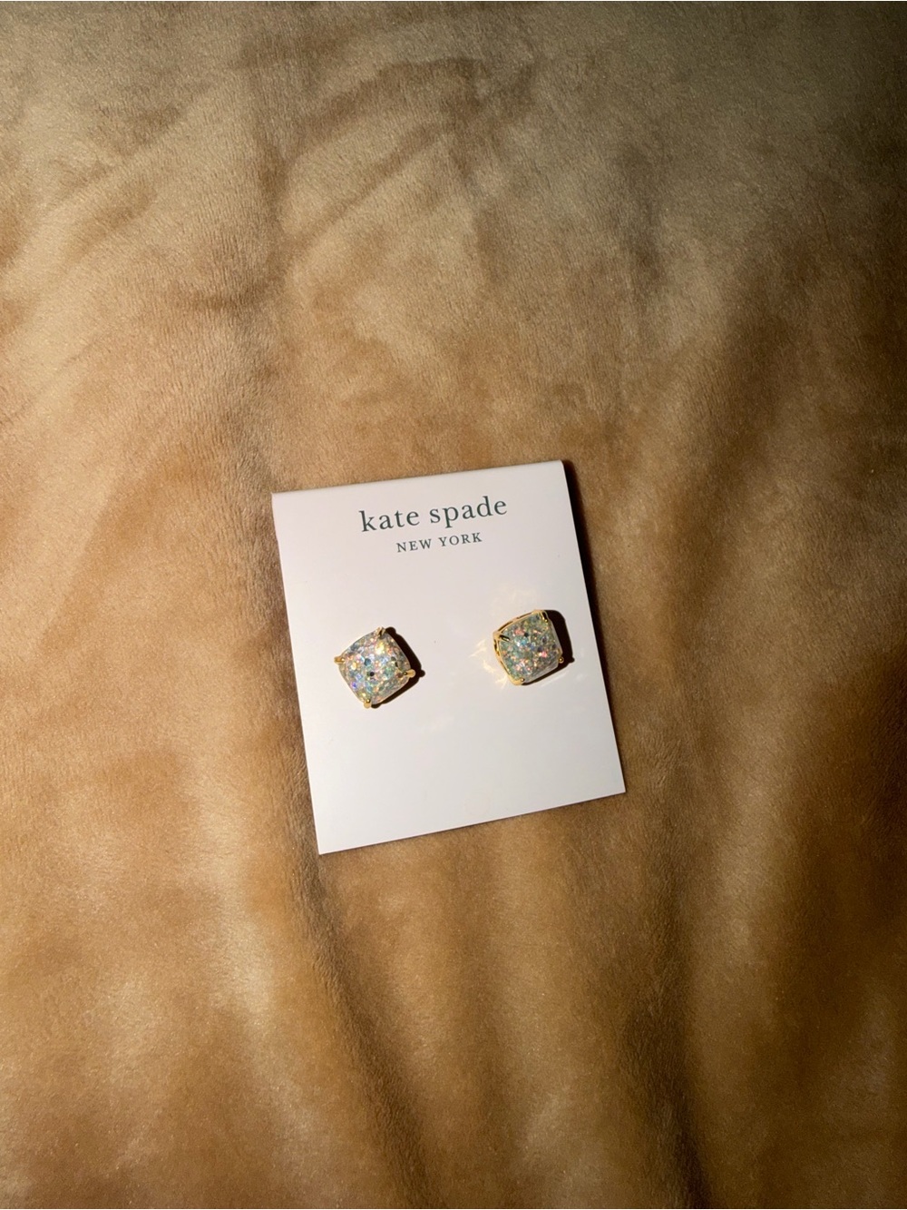 kate spade gold stud earrings on pink card